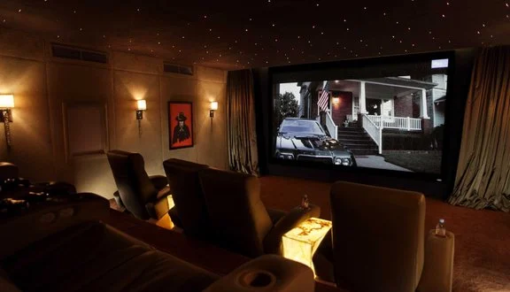 Eight-seat home cinema room with trapezoid plan and star effect ceiling, Dubai