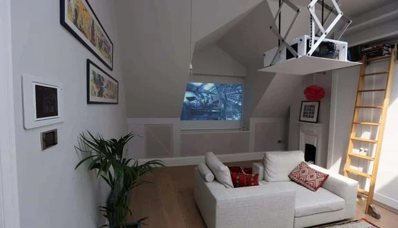 Attic home cinema with retractable projector screen, North London